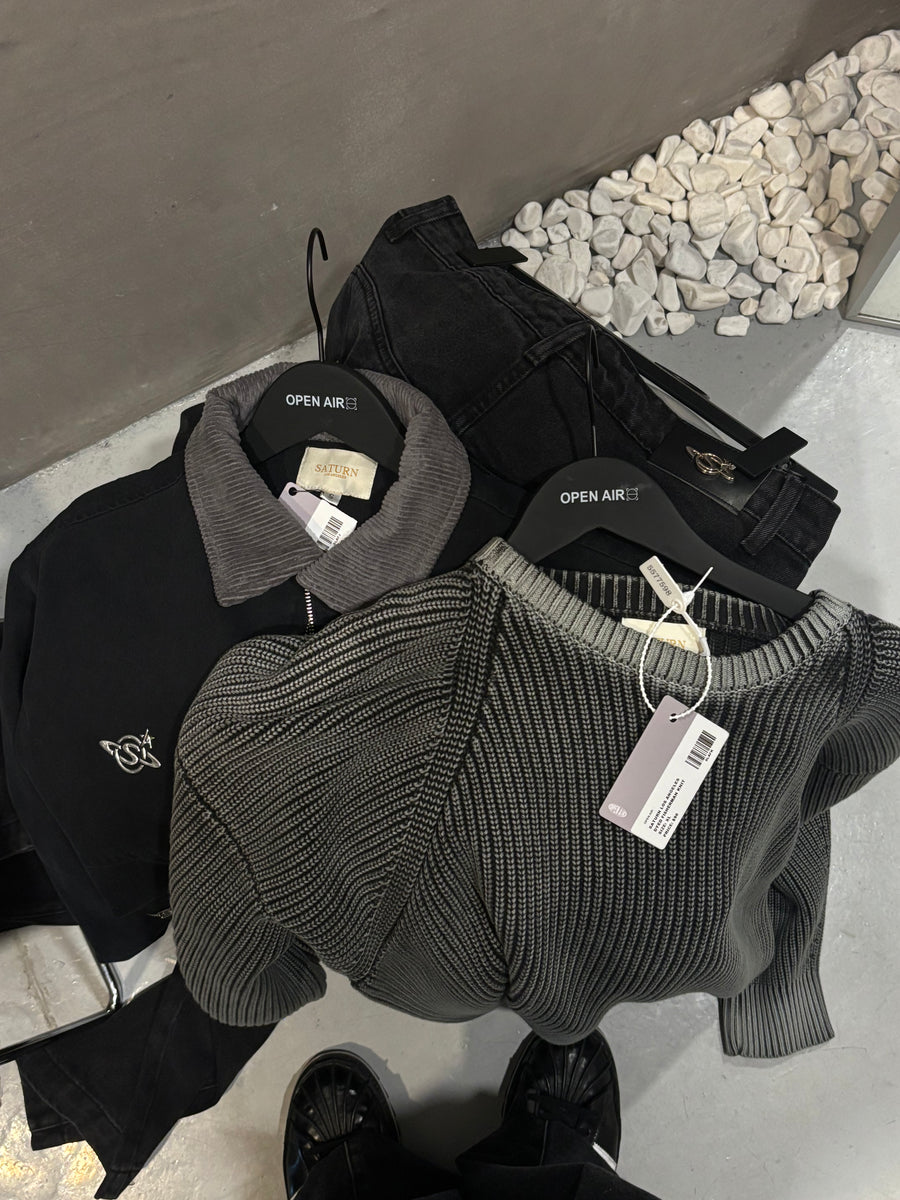 Saturn knits and jackets laid out on a shop floor