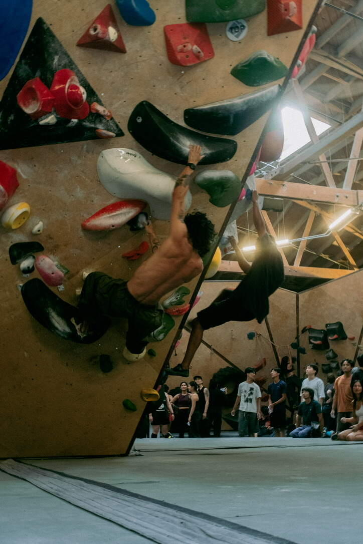 Climber on the steep wall over the crowd at Long Beach Rising
