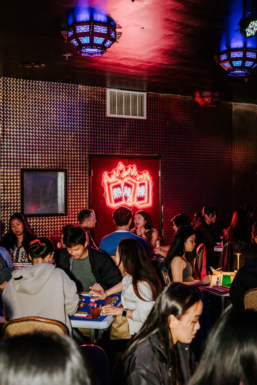 Full tables in the red room during the mahjong night